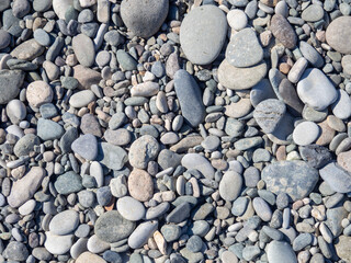 Pebbles on the beach. Background from stones. Smooth gray stones.