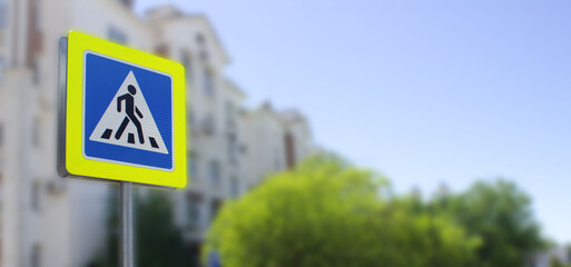 square road sign crosswalk close up on blurred background. A pedestrian crosswalk signpost symbol 