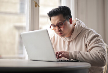 young man works with a laptop