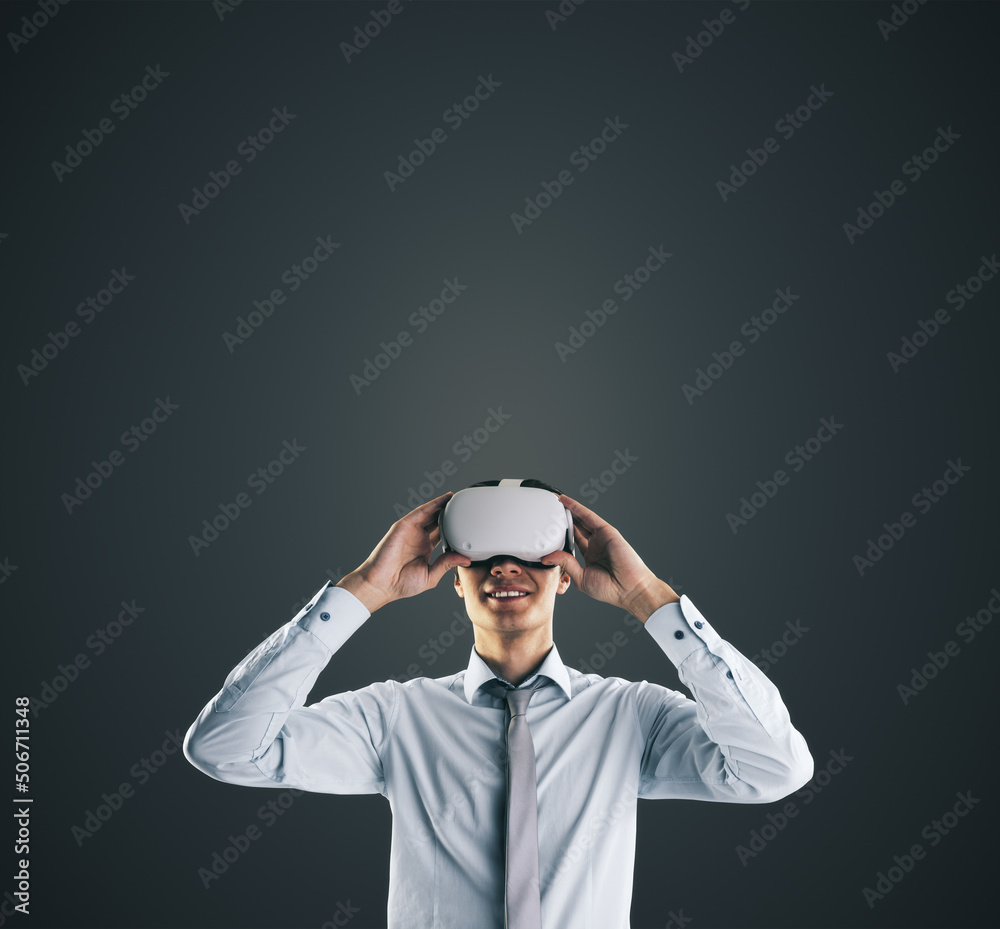 Poster virtual reality concept with young businessman gets new emotions in vr glasses on abstract black bac