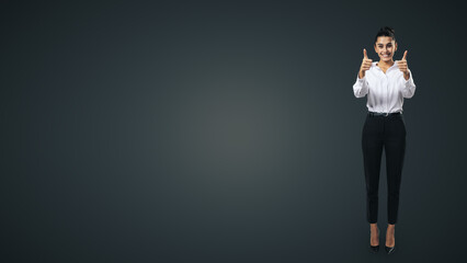 Like concept with happy young businesswoman in white shirt and black trousers holding thumbs up and standing full length on black wall background with empty place for you text, mock up