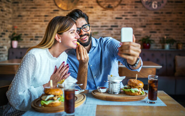 Young couple sitting in a cafe, having breakfast. Love, dating, food, lifestyle concept