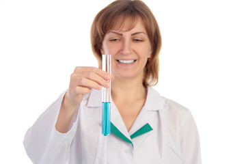 Female scientist examining a chemical reaction in a test tube