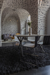 modern luxury design of a brutal apartment interior with arches in the style of a medieval castle with bright accents. free layout, kitchen area, seating and eating area.