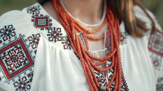Ukrainian woman in embroidery vyshyvanka dress and ancient coral beads. Traditional antique jewelry necklace and costume of Ukraine.