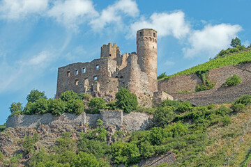Obraz premium The ruins of Ehrenfels castle, built in 1212, is perched on a rocky promontory along the Rhine River in Germany.