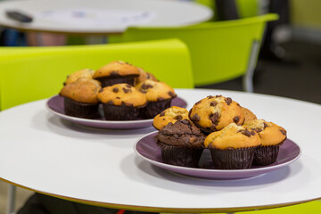 Chocolate chip muffins In the workplace breakout room. Sweet office perks. Boosting team morale.