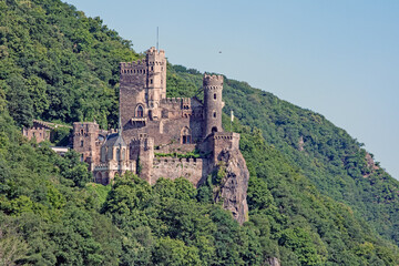 Fototapeta premium The 14th century Rheinstein Castle perched in steep hills along the Rhine River in Germany.