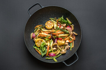 Wok pan with vegetables. Food photography, dark moody