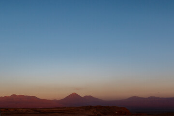 Sunset at the Moon Valley (Valle de la Luna) with the Licancabur volcano, Atacama, Chile, South...