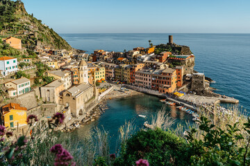 Aerial view of Vernazza and coastline of Cinque Terre,Italy.UNESCO Heritage Site.Picturesque colorful village on rock above sea.Summer holiday,travel background.Italian Riviera landscape.Steep cliff