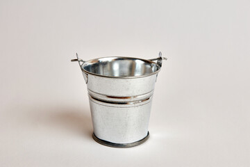 Miniature metal bucket on a white background.