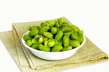 fresh green chickpeas pod in bowl isolated on white background with copy space
