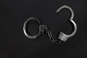 metal handcuffs on black