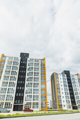 Fototapeta premium New modern multi-storey residential building. Plastic windows in a new apartment. Apartment with a balcony.