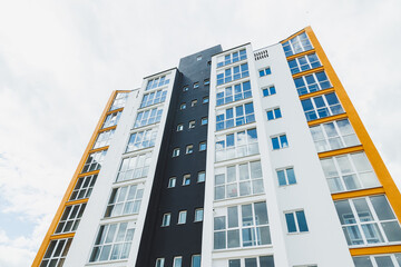 New modern multi-storey residential building. Plastic windows in a new apartment. Apartment with a balcony.
