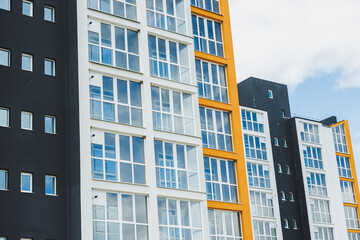 New modern multi-storey residential building. Plastic windows in a new apartment. Apartment with a balcony.