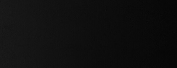 Black wall texture. Background of black plaster in the dark