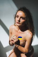 War in Ukraine, prehistory of the Ukrainian conflict. The Ukrainian flag draws on the woman's body....