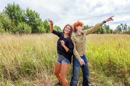 Summer holidays vacation happy people concept. Loving couple having fun together in nature outdoors. Happy young man dancing hugging with his girlfriend. Happy loving couple outdoor at summertime