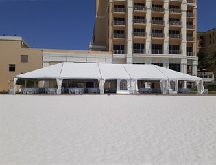 a large white events or entertainment tent on the beach - 506722163