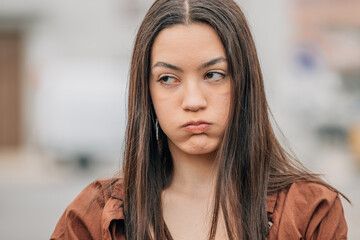 girl with expression of anger or fury outdoors