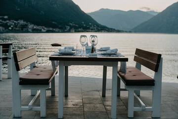 Restaurant Against the backdrop of the mountains. Cafe right by the sea. Reserved table for dinner date.