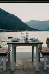 Restaurant Against the backdrop of the mountains. Cafe right by the sea. Reserved table for dinner date.