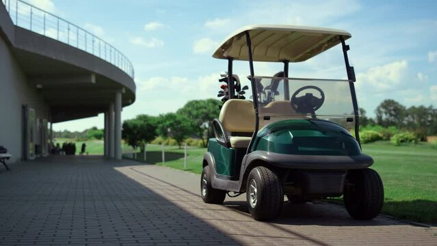 Golf cart stand field at country club. Empty car wait players on golfing game.