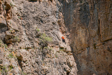 red rock climber on rock