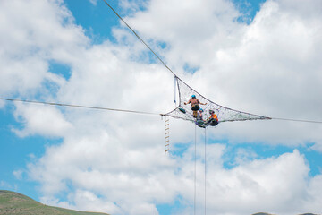 big handmade spider web and cloudy sky