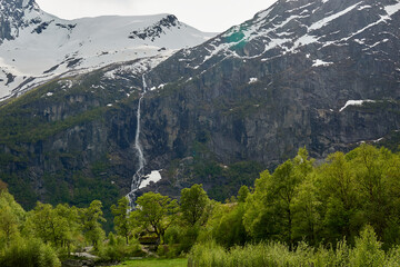 Briksdalsbre glacier. Late afternoon. Fast stream. Glacier waterfall. Spring in Norway. Jostedalsbreen National Park.
