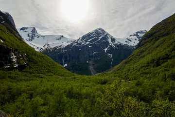 Briksdalsbre glacier. Late afternoon. Fast stream. Glacier waterfall. Spring in Norway. Jostedalsbreen National Park.