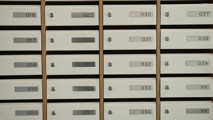 Mailboxes.Stockfootage.Closely removed mailboxes located in the entrance with the signature of apartment numbers.
