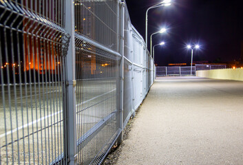 gray metal fence in a car park, property protection, security, paid parking
