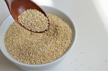 Quinoa seed for healthy eating in a white plate with a spoon