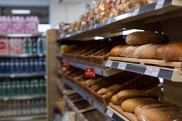 Focus on shelves with bread in a supermarket
