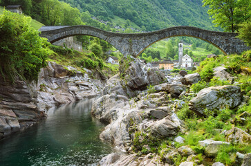Fototapeta na wymiar Stone bridge and church in Lavertezzo village, Alps mountains, Switzerland