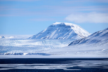 Svalbard. Snow in late spring. Midnight sun. Snowmobiles and Boats. Sun and clouds. Glaciers. North...