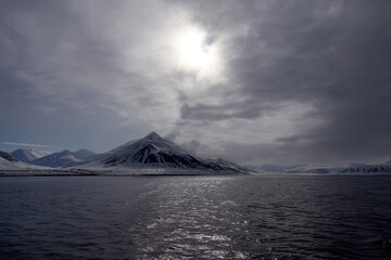 Svalbard. Snow in late spring. Midnight sun. Snowmobiles and Boats. Sun and clouds. Glaciers. North...