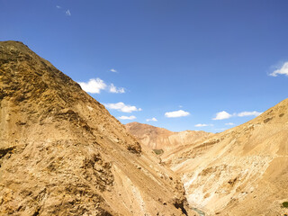 Sand valley in the summer season with blue sky and clouds 