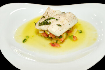 Fish fillet  with vegetables and sauce. Fish dish in a restaurant