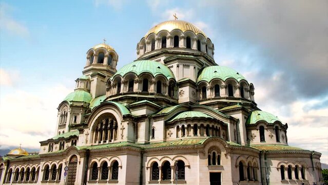 Exterior of the Alexander Nevsky cathedral in the center of Sofia, capital city of Bulgaria, on a sunny day for a tourist travel report - quick timelapse with a blue sky with clouds