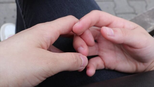 nervous girl hand movements from close up, playing as a sign of a feeling of stress or anxiety - female insecurity symbol, snapping fingernails