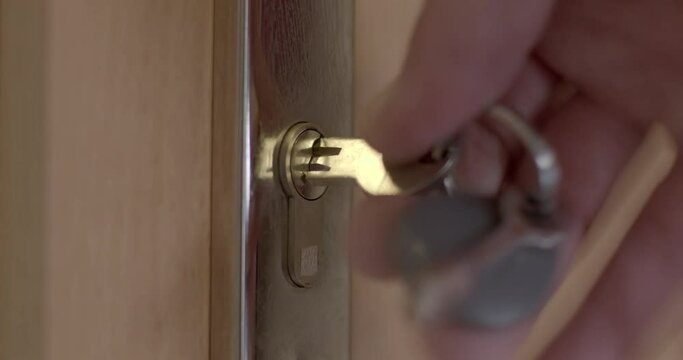 Close-up of the key getting into the lock. Jammed mechanism. The hand quickly moves the key, vibrates to unlock the door.