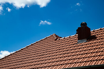 Naklejka premium new red tiles roof and blue sky