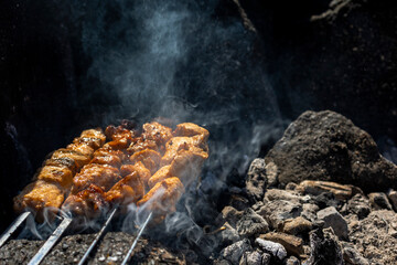 Cooking barbecue on hot coals.