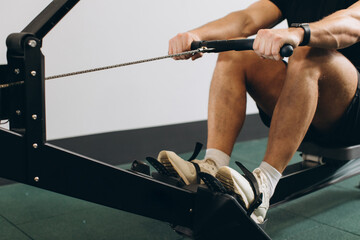 Man running rowing excercise in the gym © anatoliycherkas