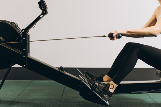 Woman exercising on rowing machine, part of circuit training warmup cardio session