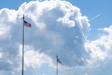 Flags of the USA, white clouds in the background